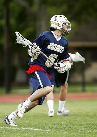 Man in Blue and White Jersey Playing Lacrosse